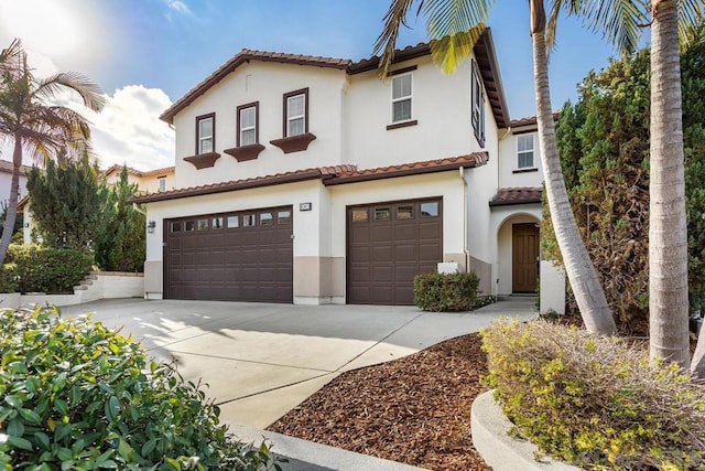 mediterranean / spanish home with a garage