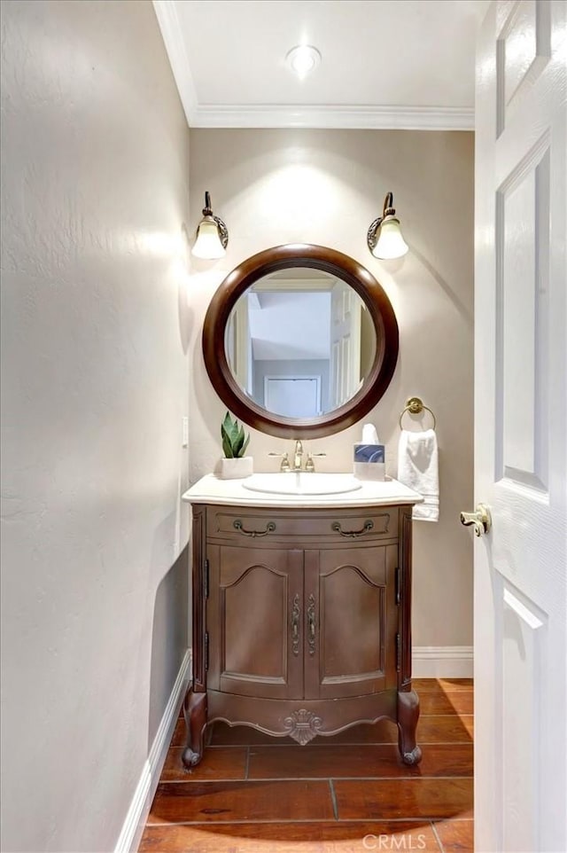 bathroom with ornamental molding and vanity