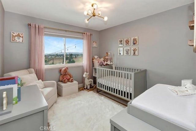 26481 Montebello Pl, Mission Viejo, CA 92691 - bedroom featuring a crib, baseboards, and a chandelier
