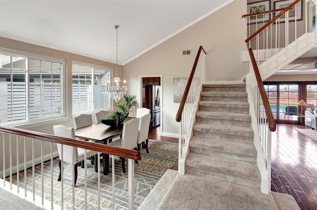 26481 Montebello Pl, Mission Viejo, CA 92691 - dining space featuring crown molding, a chandelier, visible vents, and wood finished floors