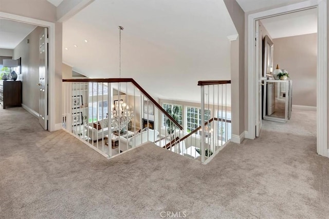 26481 Montebello Pl, Mission Viejo, CA 92691 - hallway with carpet floors, baseboards, vaulted ceiling, a notable chandelier, and an upstairs landing