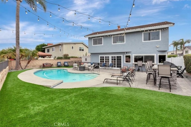 26481 Montebello Pl, Mission Viejo, CA 92691 - rear view of house with a lawn, a fenced backyard, stucco siding, and a fenced in pool