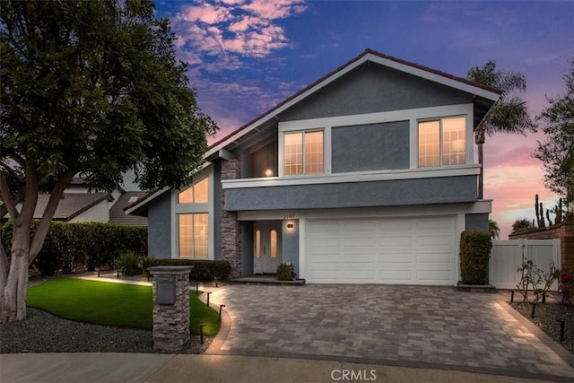 26481 Montebello Pl, Mission Viejo, CA 92691 - view of front of home featuring a garage, fence, driveway, and stucco siding