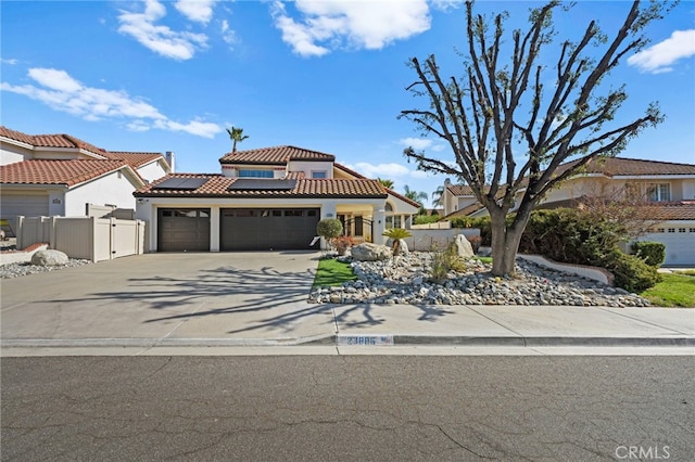 mediterranean / spanish-style home featuring a garage and solar panels