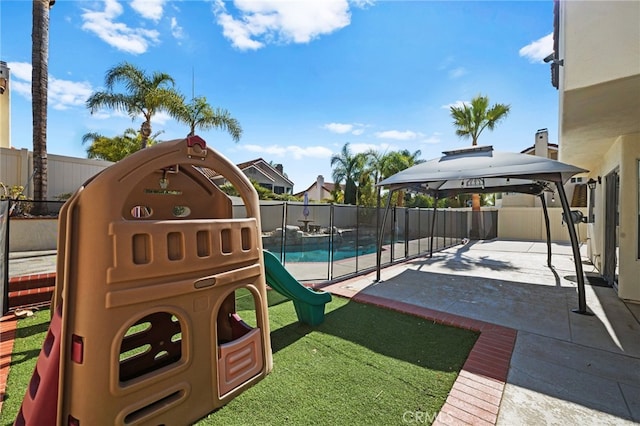 exterior space with a fenced in pool, a gazebo, a playground, and a patio area