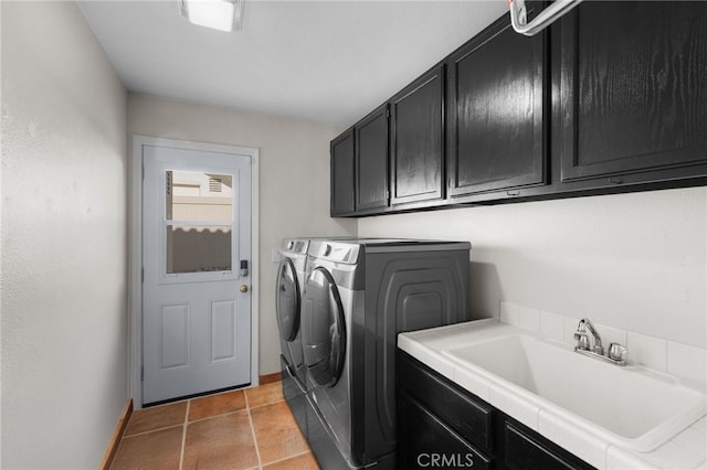 laundry room with independent washer and dryer, sink, cabinets, and light tile patterned floors