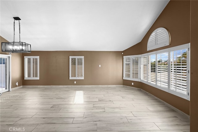 unfurnished living room featuring vaulted ceiling and light hardwood / wood-style floors