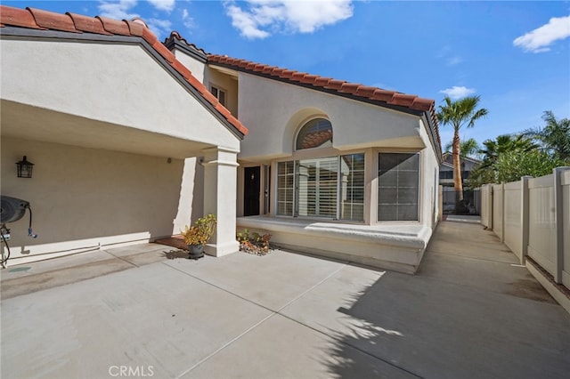 back of property with a patio