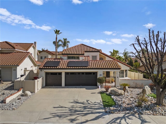 mediterranean / spanish home with a garage and solar panels