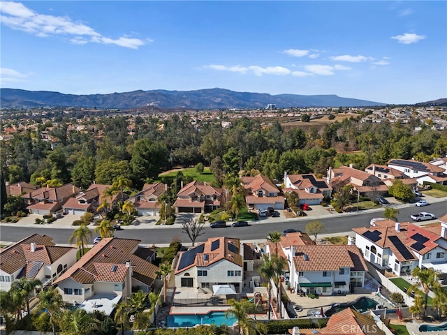 birds eye view of property with a mountain view