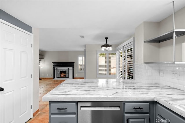 kitchen with decorative light fixtures, gray cabinetry, decorative backsplash, stainless steel dishwasher, and light tile patterned floors