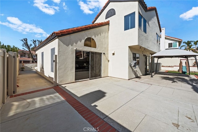 back of house with a gazebo and a patio area