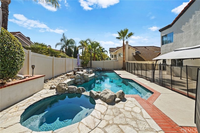 view of pool featuring a patio and an in ground hot tub