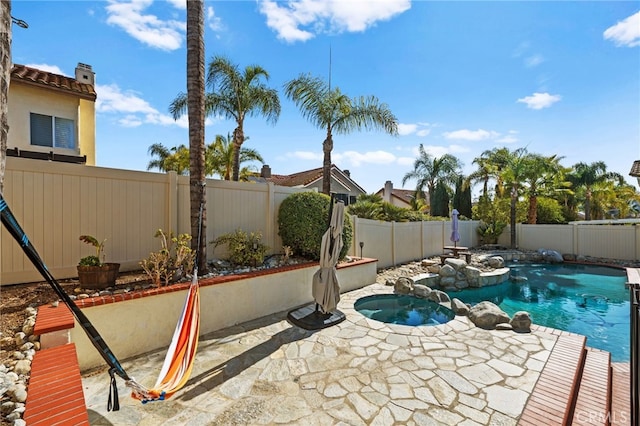 view of pool featuring an in ground hot tub and a patio