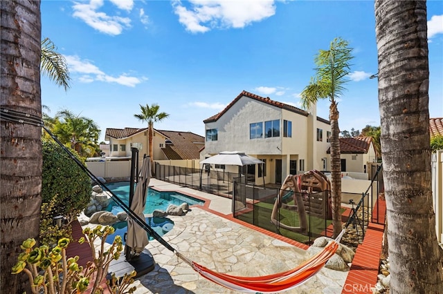 view of pool with a playground and a patio area