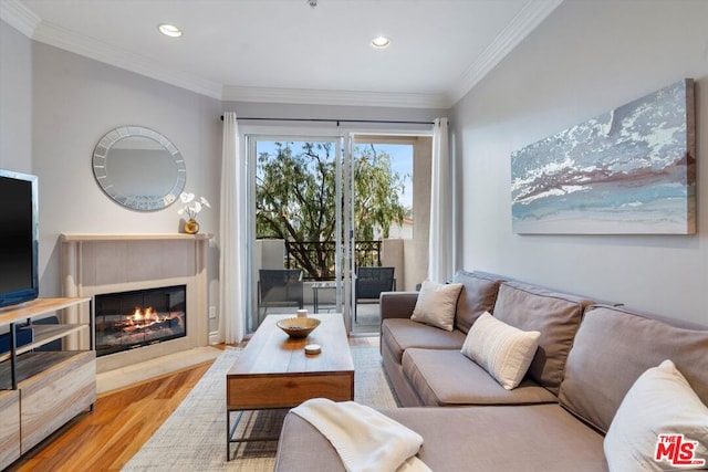 living room featuring light hardwood / wood-style flooring and ornamental molding