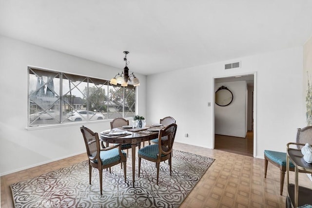 dining area featuring an inviting chandelier