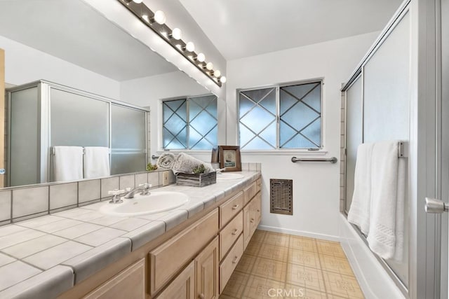 bathroom with bath / shower combo with glass door and vanity