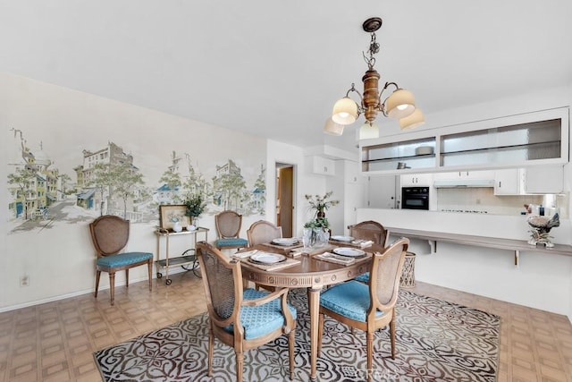 dining area featuring an inviting chandelier