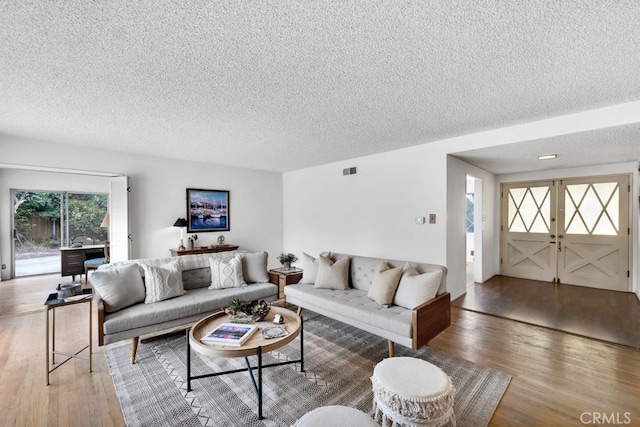 living room featuring hardwood / wood-style flooring and a textured ceiling