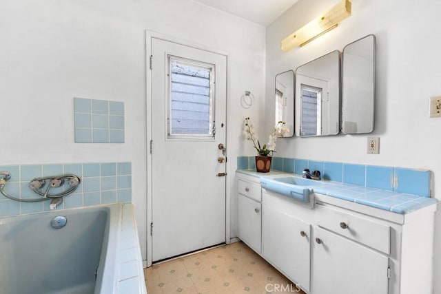 bathroom featuring vanity and a bathtub