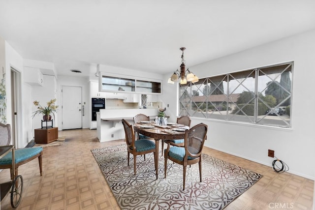 dining space with an inviting chandelier