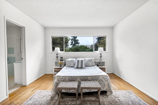 bedroom featuring hardwood / wood-style flooring and a textured ceiling