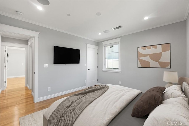 bedroom with ornamental molding and wood-type flooring