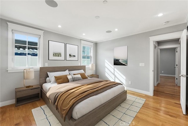 bedroom with crown molding and light hardwood / wood-style floors