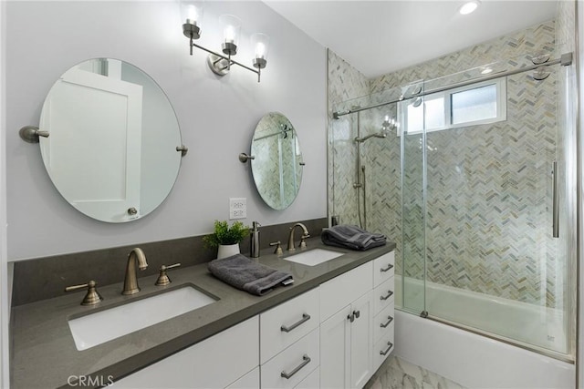 bathroom featuring enclosed tub / shower combo and vanity