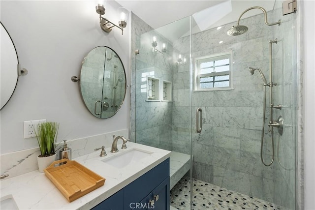 bathroom featuring vanity and a shower with shower door