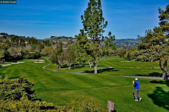 surrounding community featuring a mountain view and a yard