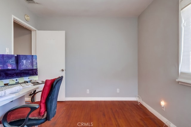 home office with hardwood / wood-style floors