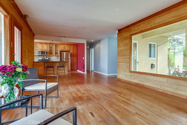 living room featuring wooden walls and light wood-type flooring