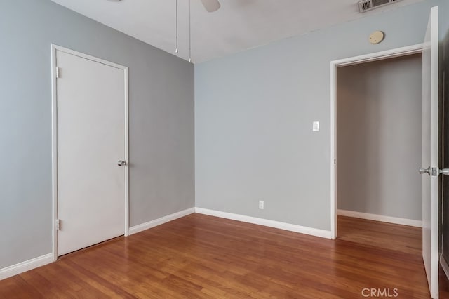 empty room featuring ceiling fan and hardwood / wood-style floors