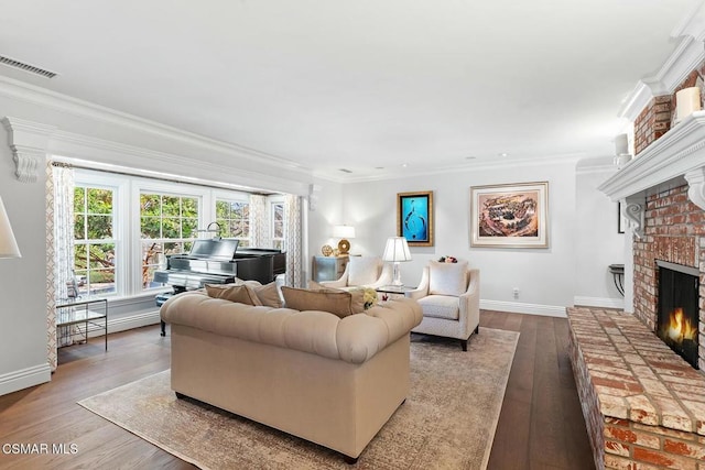 living room featuring crown molding, a brick fireplace, and hardwood / wood-style flooring