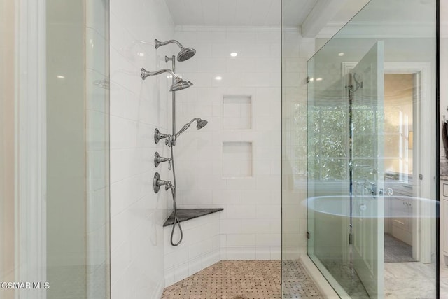 bathroom with crown molding and a shower with door