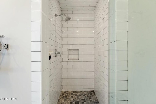 bathroom with tiled shower