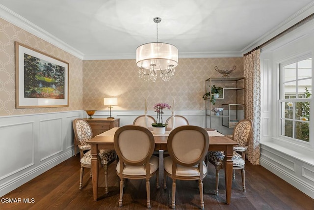 dining room with ornamental molding, dark hardwood / wood-style floors, and a chandelier