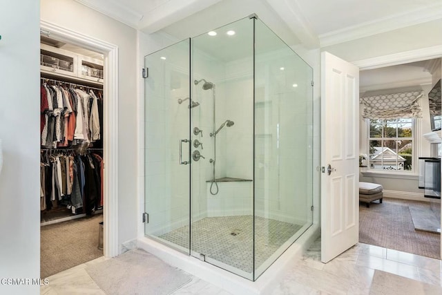 bathroom featuring a shower with door and crown molding