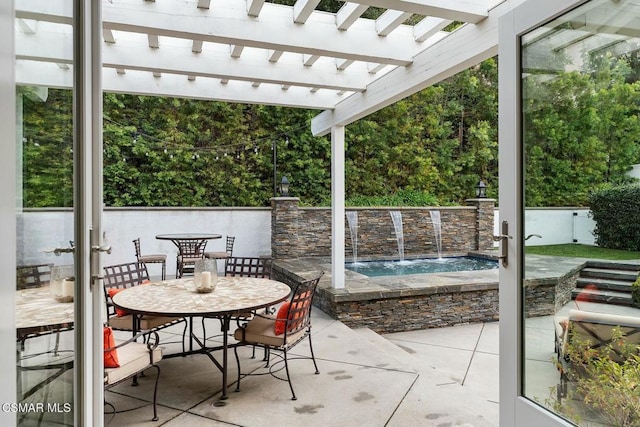 view of patio / terrace featuring pool water feature, a pergola, and a jacuzzi