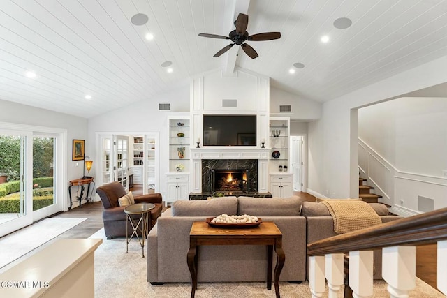 living room with wood ceiling, lofted ceiling with beams, light hardwood / wood-style flooring, ceiling fan, and a high end fireplace