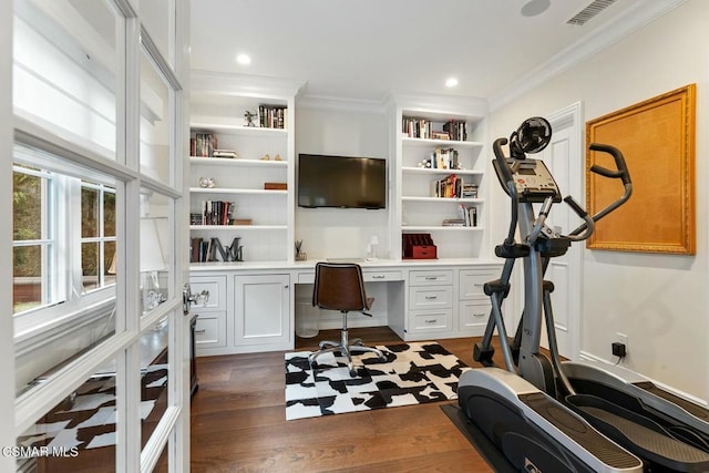 office space featuring ornamental molding, dark hardwood / wood-style flooring, and built in desk