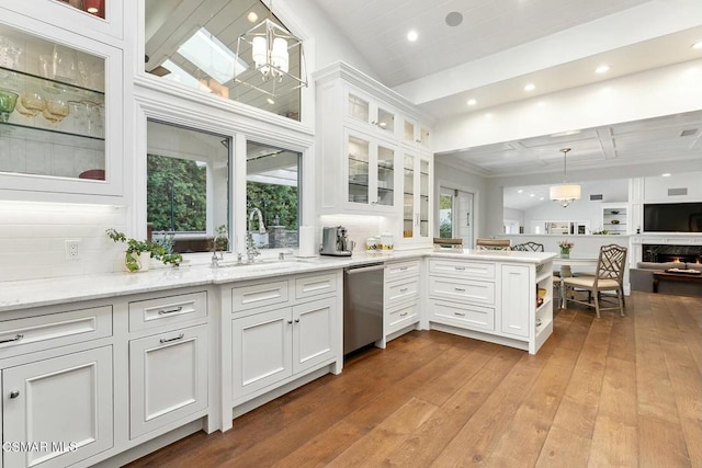 kitchen with dishwasher, hanging light fixtures, and white cabinets