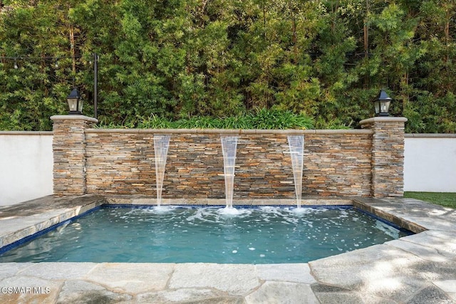 view of pool with pool water feature