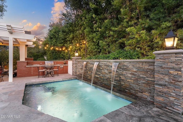 pool at dusk with a patio area