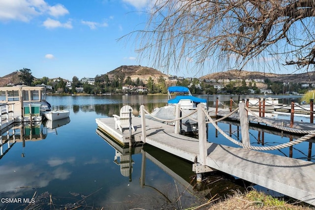 dock area featuring a water and mountain view