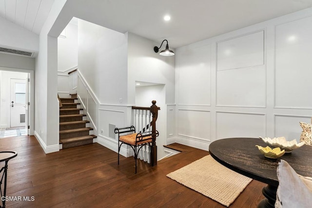 sitting room featuring lofted ceiling and dark wood-type flooring