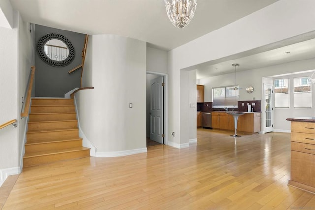 stairway featuring hardwood / wood-style flooring and an inviting chandelier