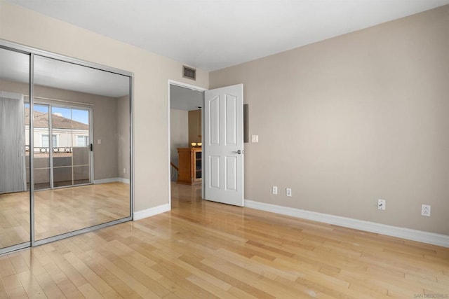 unfurnished bedroom featuring light hardwood / wood-style floors and a closet